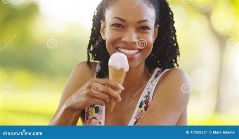 Black Woman Smiling And Eating Ice Cream Stock Image Image Of Field