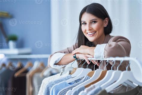 Young woman as a store manager with clothes 15878942 Stock Photo at Vecteezy