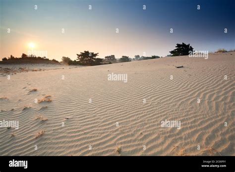 Sunrise Over Sand Dunes Stock Photo Alamy