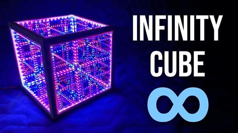 The Infinite Cube Is Lit Up In Purple And Blue Lights With Text