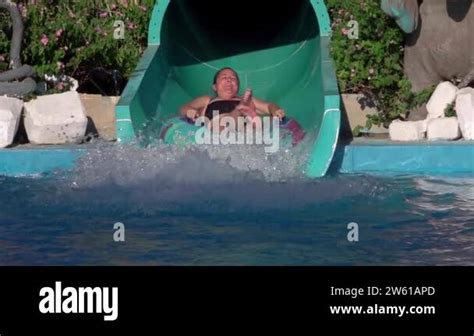 Girl Riding A Water Slide Happy Woman Going Down On Water Slide In The