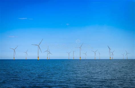 Offshore Wind Turbine In A Wind Farm Under Construction Off The England Coast At Sunset Stock