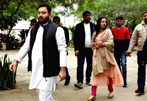 Rjd Leader Tejaswi Yadav And His Wife Rachel Godinho Distribute