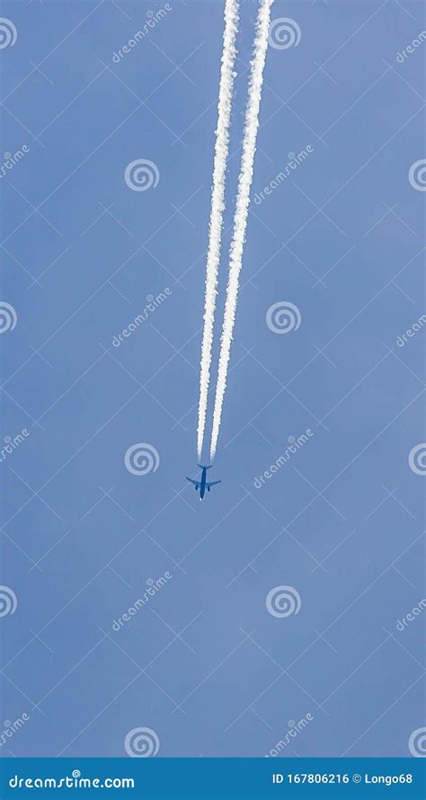 Two Engined Airplane During Flight In High Altitude With Condensation