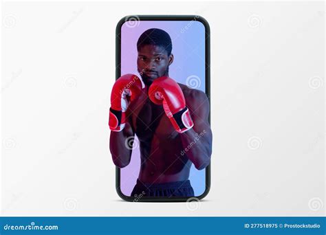 Confident Muscular Black Guy With Naked Torso And Boxing Gloves On Phone Screen Stock Image