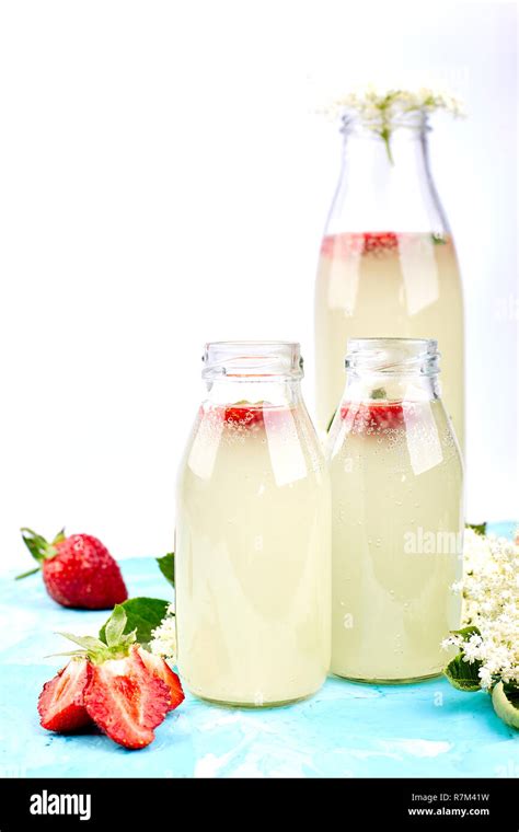 Kombucha Tea With Elderflower And Strawberry On Blue Background