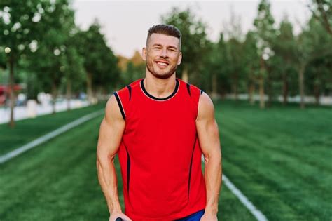 Premium Photo Portrait Of Young Man Standing On Field