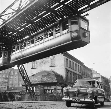 A hanging monorail train moves along the seven mile Wuppertal Monorail System in Germany, just ...