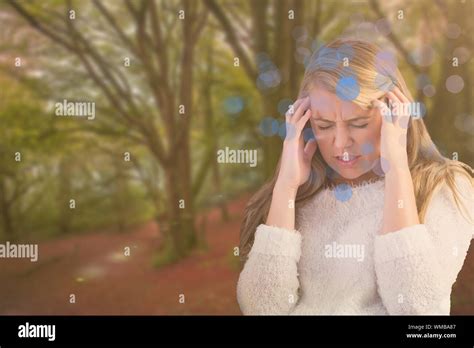 Pretty Blonde Getting A Headache On The Couch Against Peaceful Autumn