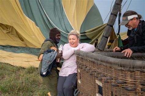 Blonde Woman Struggles To Climb Out Of The Basket After A Hot Air Balloon Ride In The Masai Mara
