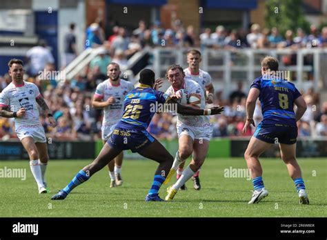 Cameron Smith 13 Of Leeds Rhinos Is Tackled By Sam Eseh 25of