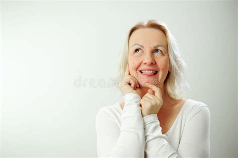 Happy Mature Blonde Lady Sitting On Couch Holding Video Call With Friends Head Shot Close Up