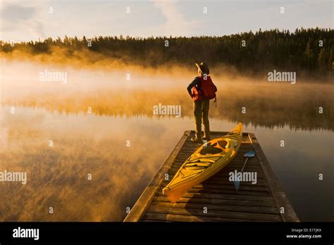 Man On Dock With Kayak Little Deer Lake Lac La Ronge Provincial Park