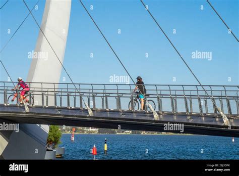 Cyclists Riding Their Bikes Over The Elizabeth Quay Bridge A Pedestrian