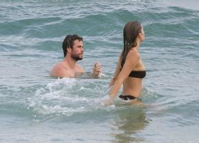 Hemsworth Shows Off His Ripped Beach Bod During A Morning Swim With Bikini Clad Girlfriend