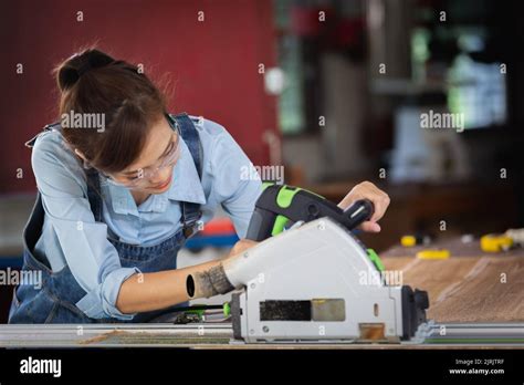 woman works   carpentry shop attractive female carpenter