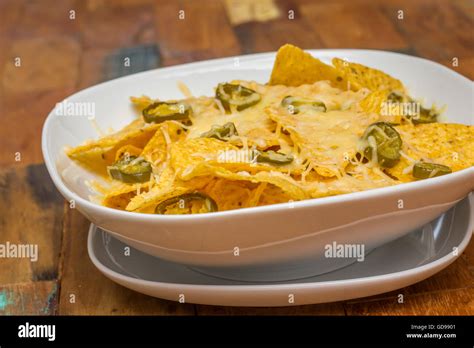 Nachos cheese with cheese and jalapenos in a white bowl Stock Photo - Alamy