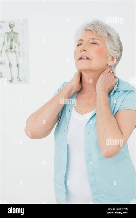 Senior Woman Suffering From Neck Pain In Medical Office Stock Photo Alamy