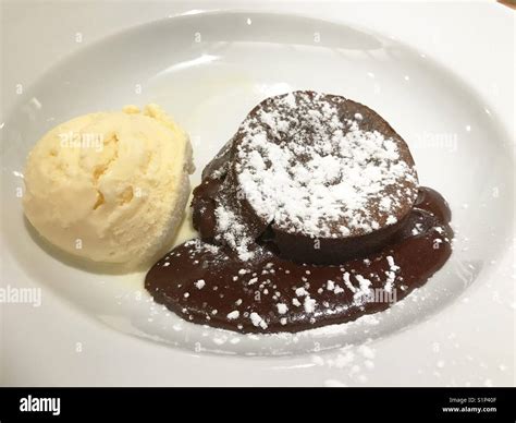 Chocolate cake with vanilla ice cream Stock Photo - Alamy