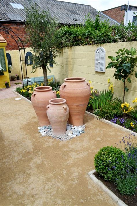 Use Terracotta Pots Yellow Walls Yellow And Purple Flowers And Olive