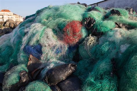 Premium Photo | Lots of used fishing nets waiting to be recycled ...