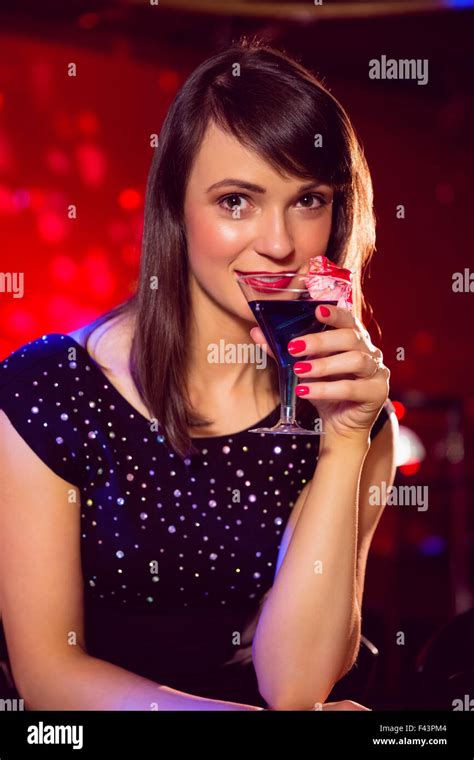 Pretty Brunette Drinking A Cocktail Stock Photo Alamy