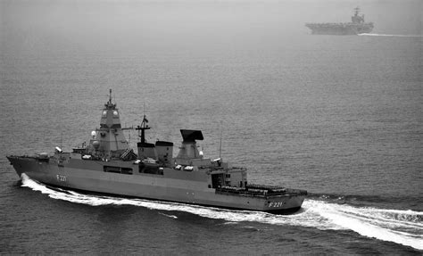 German navy frigate FGS Hessen (F221), left, holds an all hands quarters on the fan tail as it ...