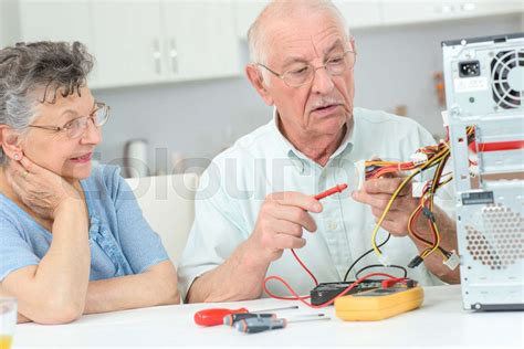 Retired Man Testing Computer With Multimeter Stock Image Colourbox