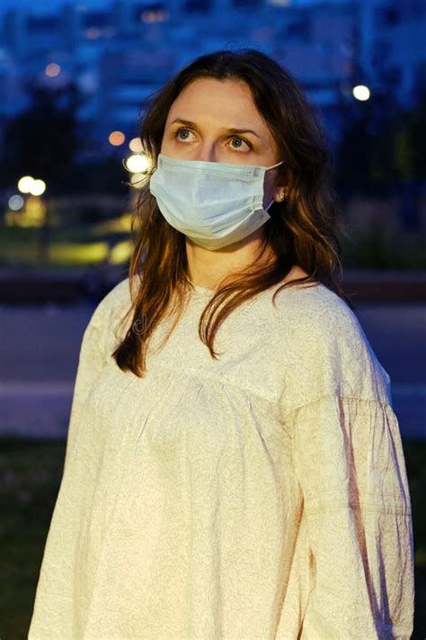 Adult Woman Puts On Face Mask On City Night Street Stock Image Image