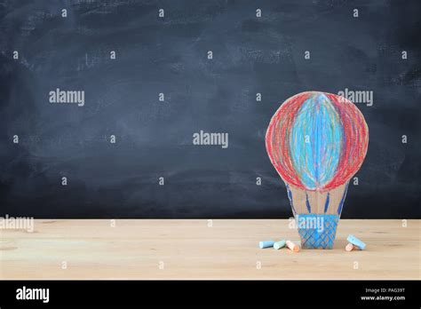 Back To School Concept Cardboard Handmade Hot Air Balloon Over Classroom Blackboard Background