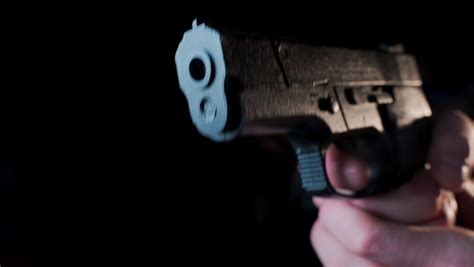 hand holding gun stock video footage   hd video clips