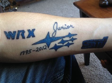 A Person With A Tattoo On Their Arm That Reads Wrx Junior And Stars