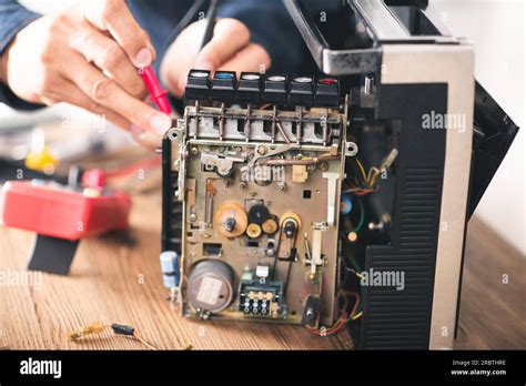 Technician repairing an old radio cassette recorder Stock Photo - Alamy