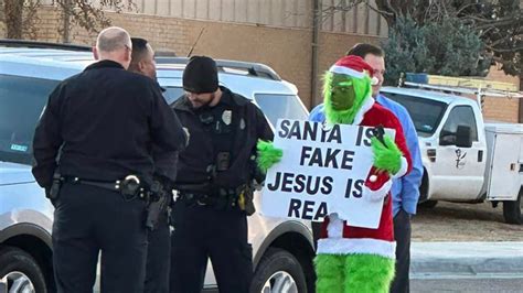 Grinch Tries To Steal Christmas Stands In Front Of Elementary School