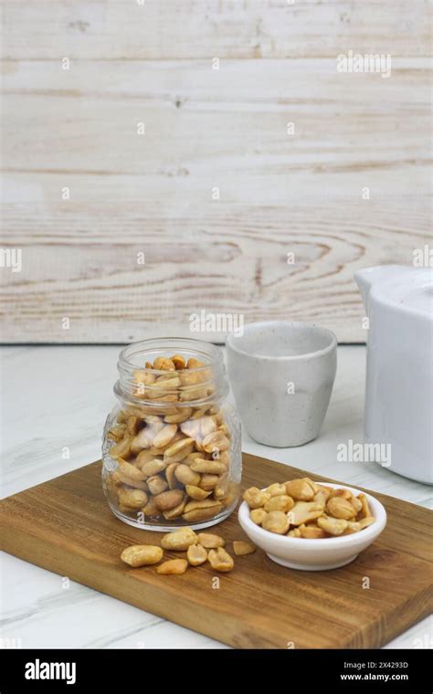 Kacang Goreng Or Fried Peanuts In A Jar And White Plate Indonesian