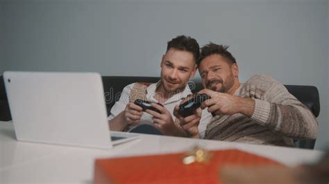 Gay Male Couple With Santa Claus Hats Cuddling And Watching Movie Sad Romantic Movie On The