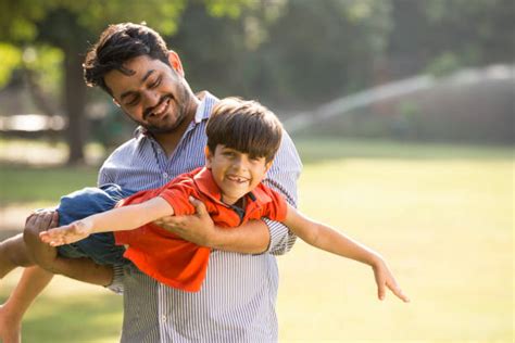 indian father carrying son   shoulders stock  pictures