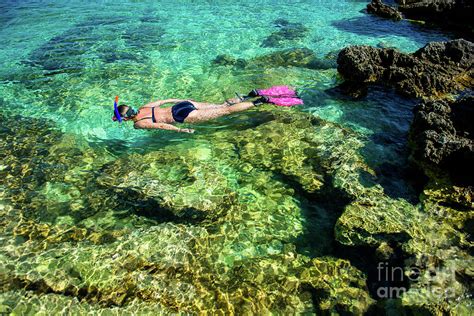 Pretty Woman In Bikini Snorkeling Through Turquoise Water At The Coast