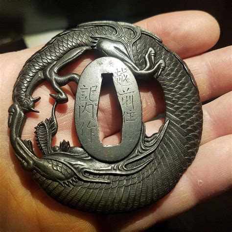 Iron Tsuba Depicting A Dragon By The Echizen Kinei Group Of Tsuba