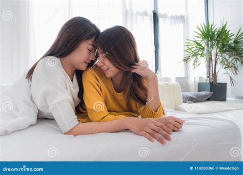 Asia Lesbian Lgbt Couple Hug And Lay On Bed Near White Window Sunlight