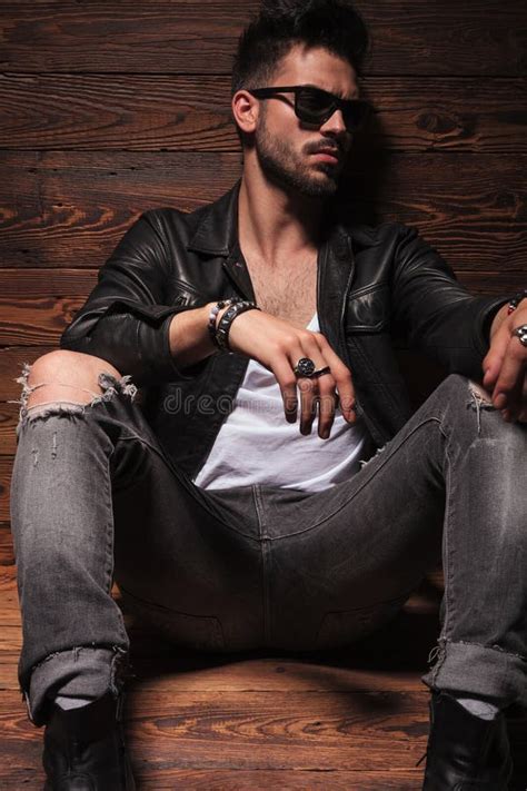 Fashion Man In Leather Jacket And Sunglasses Is Sitting Stock Photo