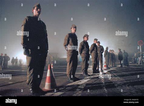 East German Border Guards Stand Behind The Border Line At