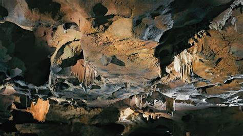 Illuminated Cave Interior With Stalactites And Stalagmites Vibrant