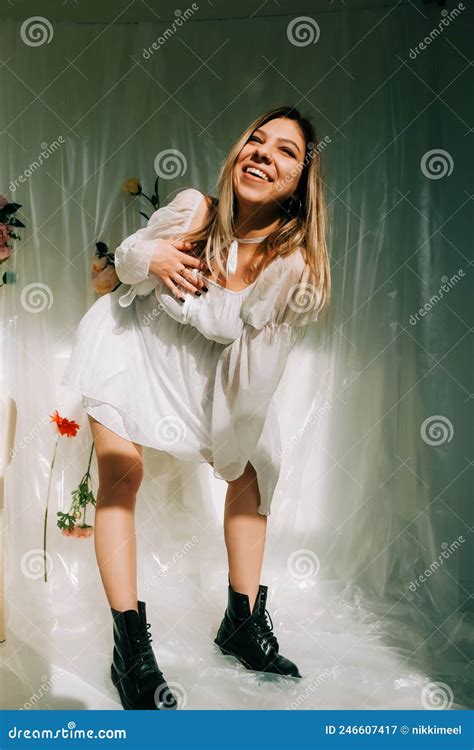 Portrait Of Attractive Caucasian Woman In Short White Dress Posing In