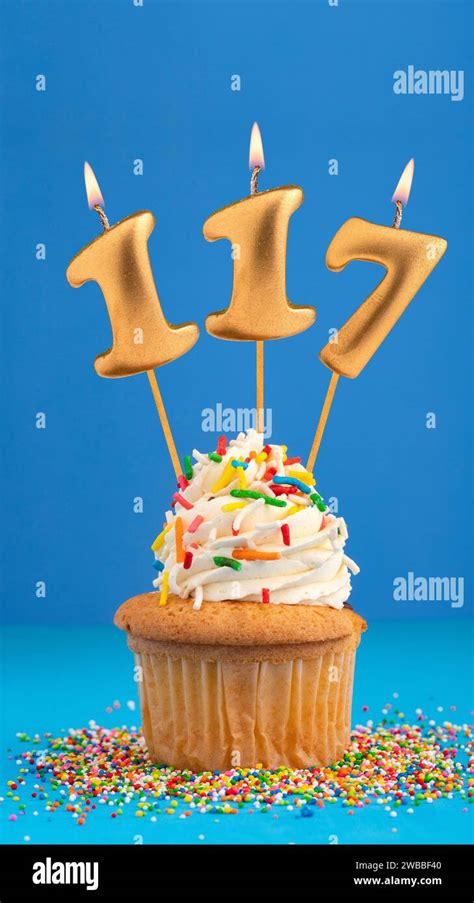 Candle number 117 - Cake birthday in blue background Stock Photo - Alamy