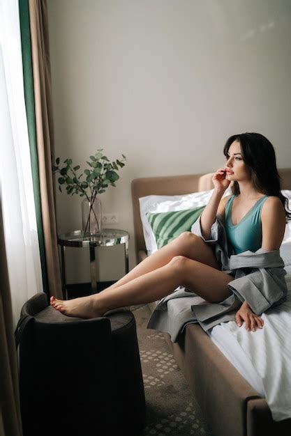 Plan latéral vertical d une jeune femme séduisante sensuelle en robe révélatrice et lingerie