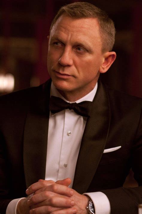 a man in a tuxedo sitting at a table