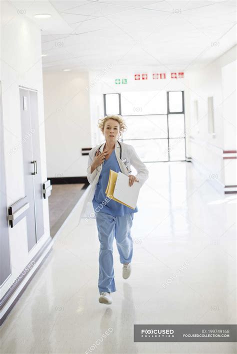 Doctor rushing down hospital corridor — Lab Coat, one person - Stock