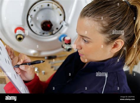 A Female Plumber Checking Boiler Stock Photo Alamy