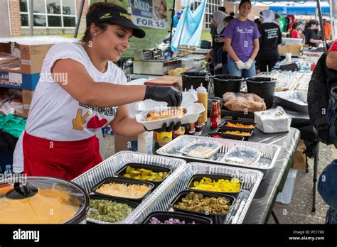 Dearborn, Michigan - A woman adds toppings to a halal hot dog at the ...